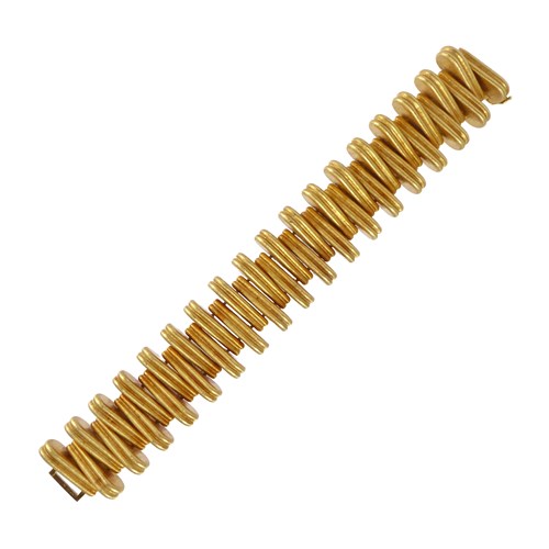 Bold reeded panel link bracelet by Cartier, made in Italy, the drop shaped panels stacked upright end-to-end, testing as 18ct gold,